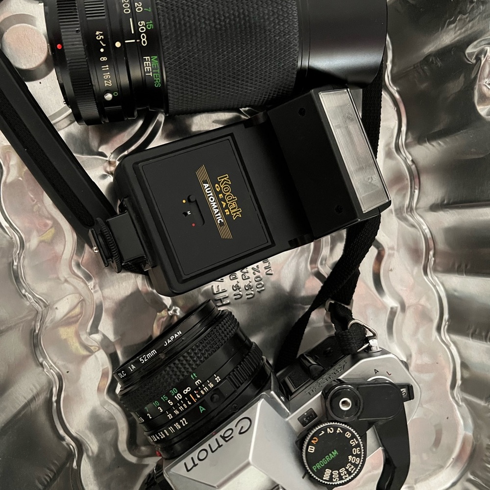 Canon AE-1 film camera with extra flash and lens